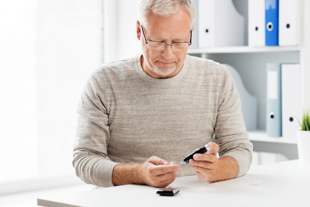 Diabetic Man Testing Blood Levels